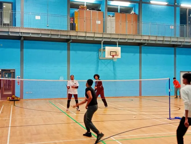 Group of Young People playing badminton