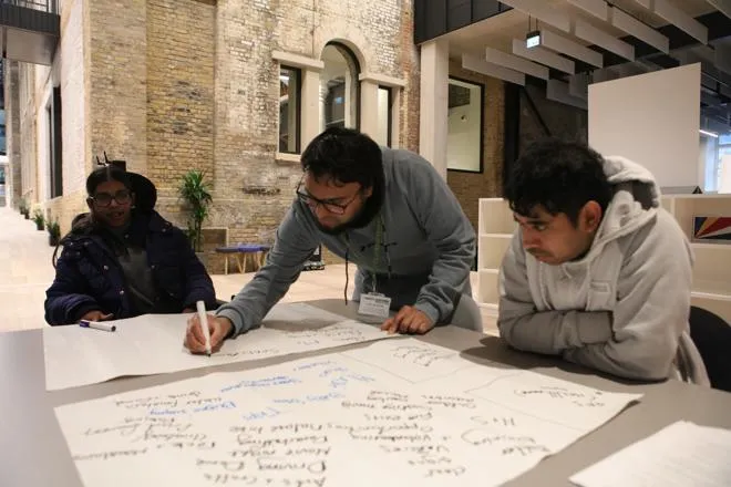 Three people creating signs