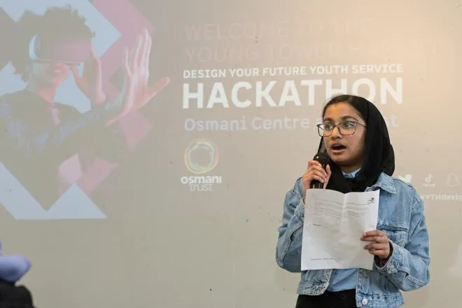 Young person speaking at an event.