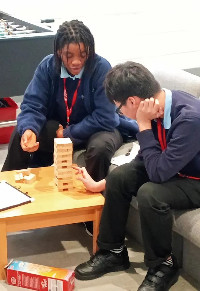 Young people playing Jenga