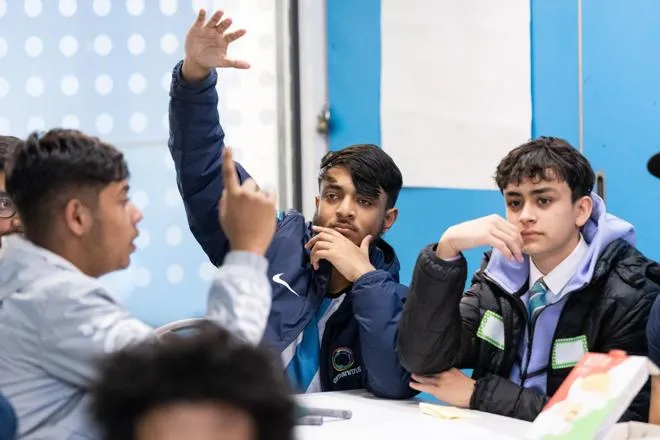 Young person with their hand up