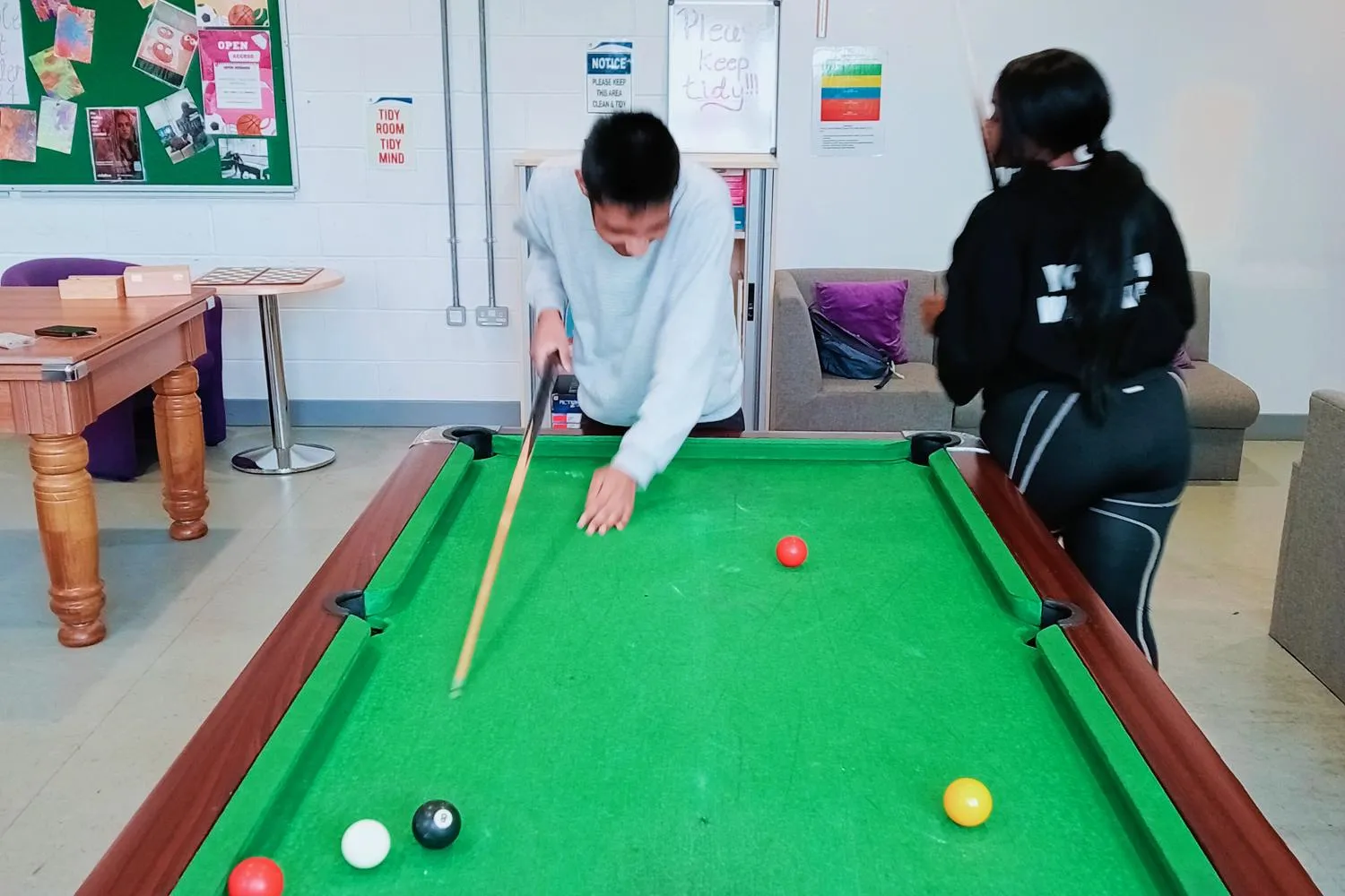 young people playing pool