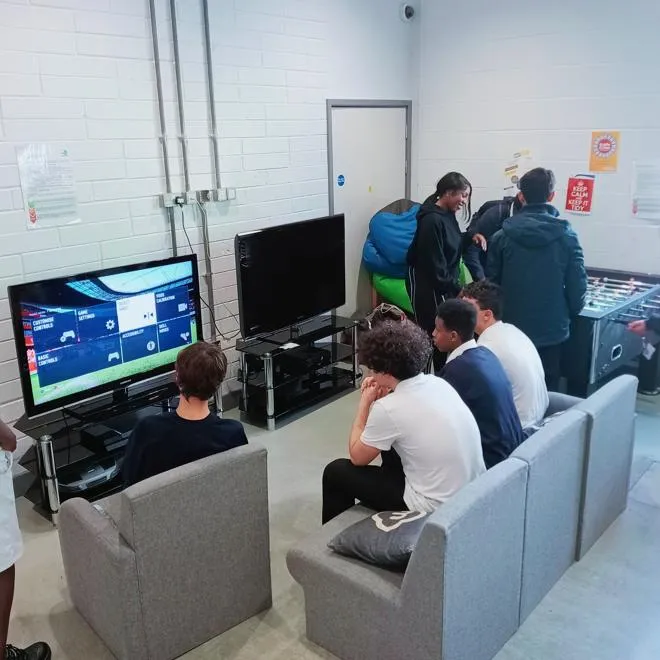 A group of Young People playing PS5