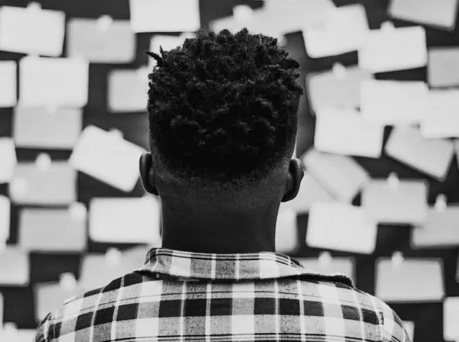 Young Person looking at ideas on a board