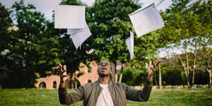 Student throwing papers