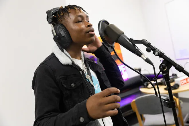 Young Person Singing into Microphone