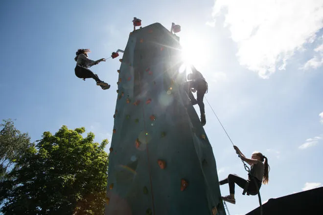 young people rock climbing