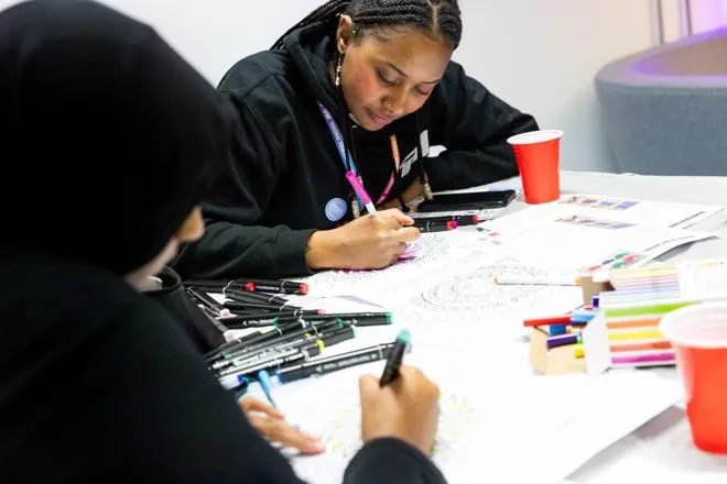 Young people drawing on paper